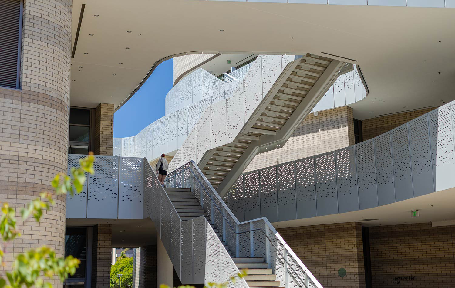photo of staircase with a student at the top walking away