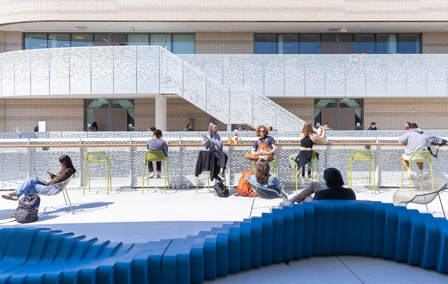 students seated outside on the second floor of the ILP building